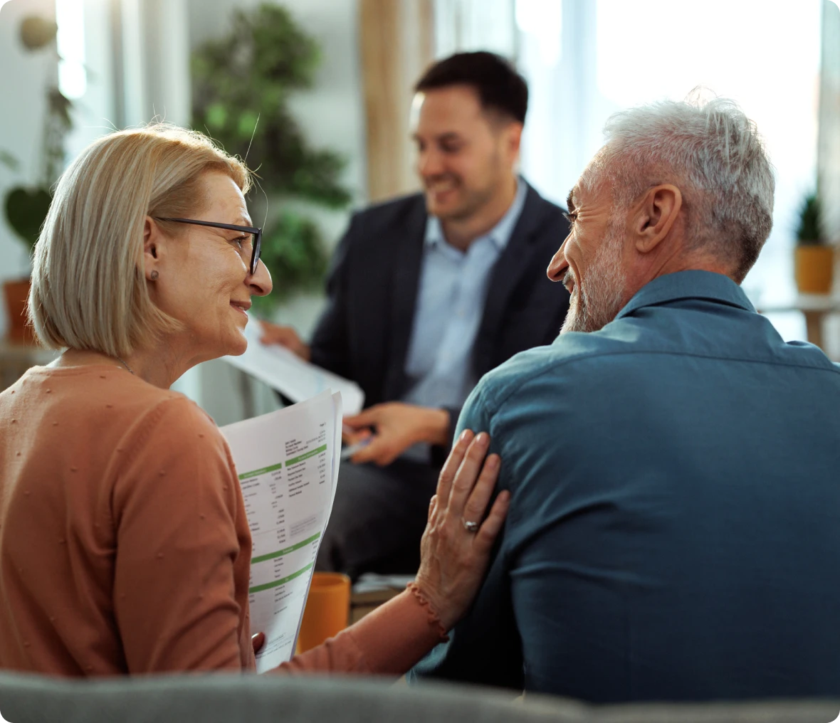 Elderly couple discussing finances with advisor